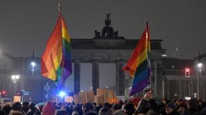 Berlin counter-demo at darkened Brandenburg Gate.